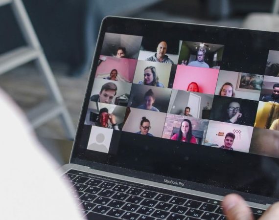 Remote team collaborating via video conferencing, showcasing the flexibility and efficiency of a business VoIP provider.